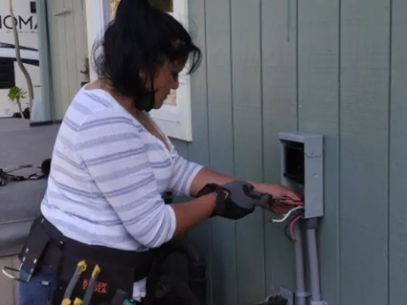 Licensed electrician wiring an exterior subpanel in Riva
